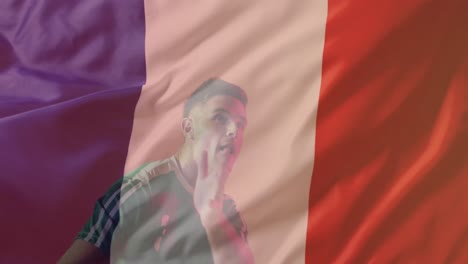 Animation-of-caucasian-male-soccer-player-over-flag-of-france