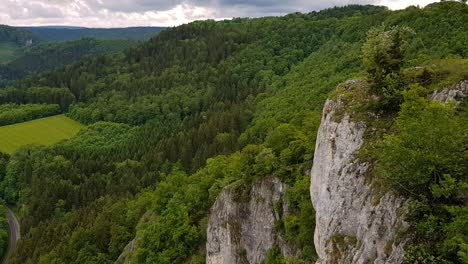 panning up off white rock formation on mountain to beautiful landscape, eichfelsen germany