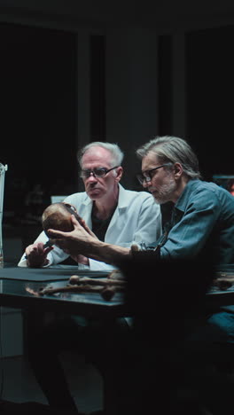scientists examining a human skull