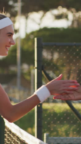 video of happy diverse female tennis players clapping hands after match