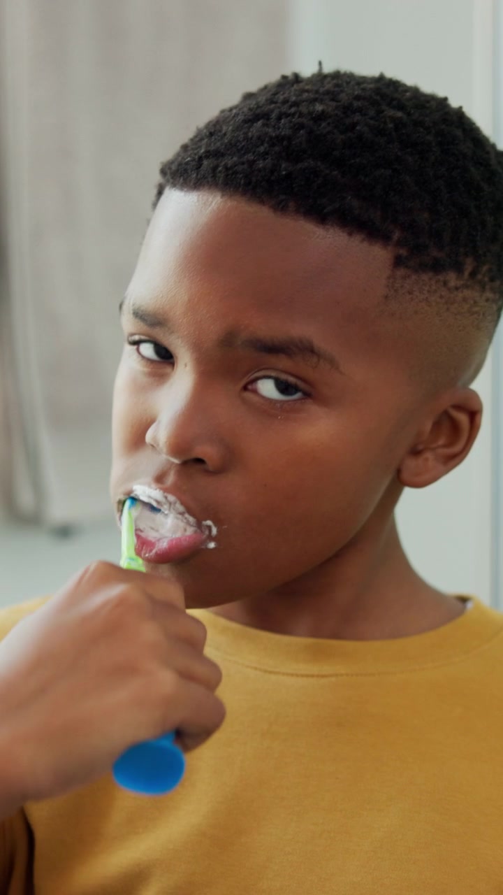 Young Boy Brushing His Teeth in the Bathroom