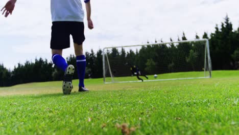 football player kicking a ball in the field