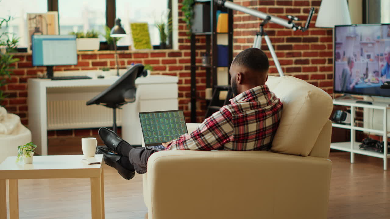 Man working on laptop in cozy home office