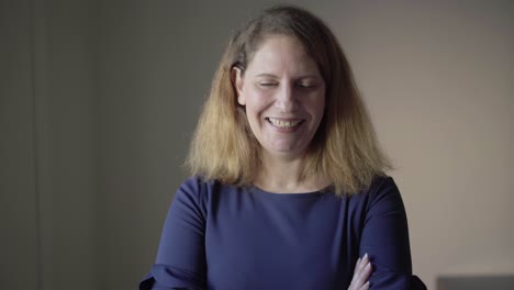 indoor closeup of positive, smiling middle aged caucasian woman