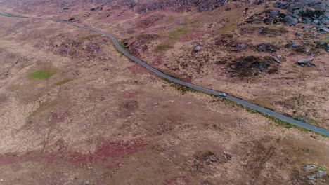 Car-driving-along-a-mountain-pass-aerial