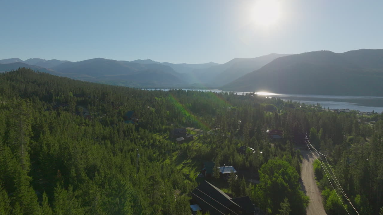 Drone shot of the mountains through the trees at sunrise in Grand Lake, Colorado