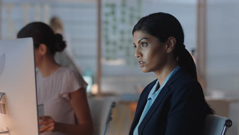 indian-business-woman-working-late-in-offce-using-computer-brainstorming-browsing-online-research-planning-deadline-for-corporate-project