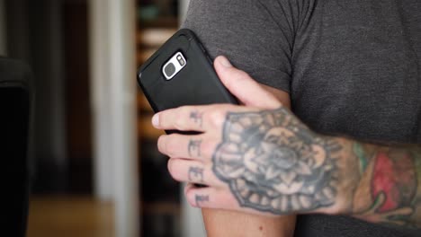 Close-up-of-a-young-and-healthy-man-with-diabetes,-using-his-phone-to-check-his-blood-glucose-level-with-a-sensor-on-his-arm