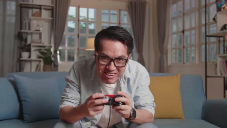 adult gamer sitting on sofa playing game in the living room and lost