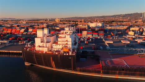 Aerial-View-Of-USNS-John-Glenn-,-Expeditionary-Transfer-Dock-Ship-In-Oakland,-California,-USA-During-Golen-Hour