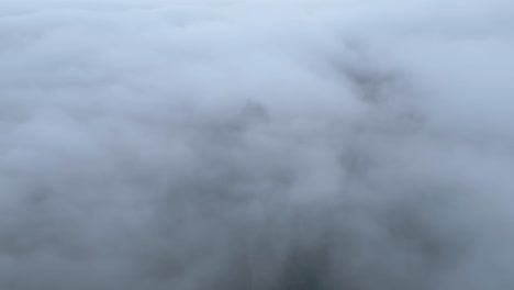 ruins on mountain peak above clouds on foggy day