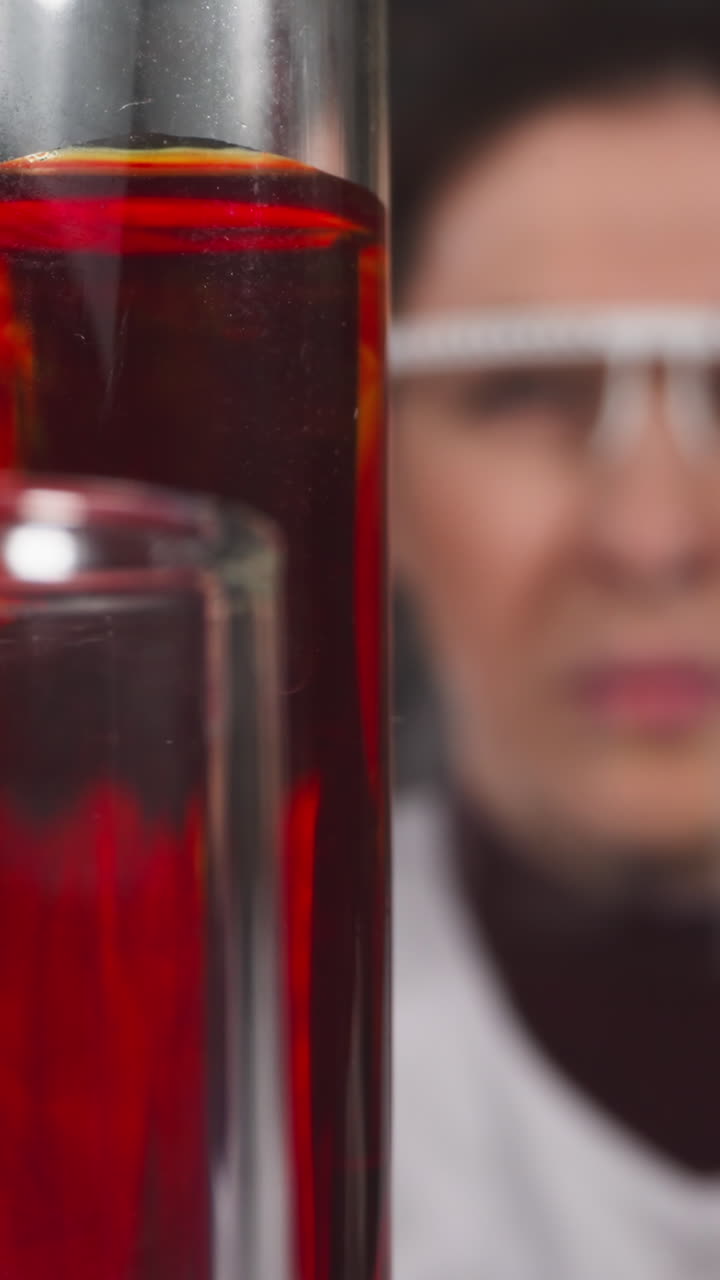 Skilled woman doctor takes blood sample from test tube with pipette in laboratory slow motion. Probe lens shot of medical experiment closeup