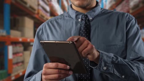 animation of caucasian man working in a warehouse and using digital tablet