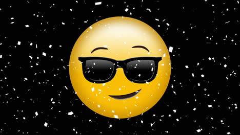 digital animation of confetti falling over face wearing sunglasses emoji against black background