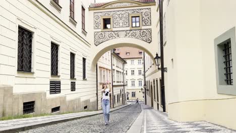 a woman tourist walks through the old streets of p 4k 2025 08 04 21 07 06 utc.mov | admiring, adventure, ambiance, architecture
