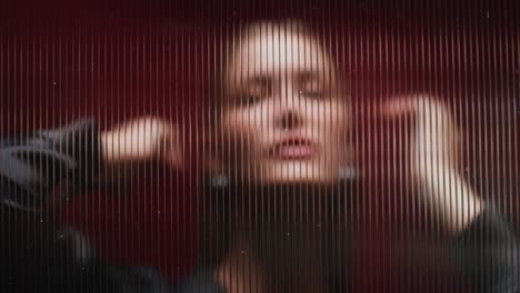 woman behind a red striped glass