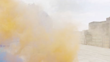 fashionable young woman on urban rooftop using smoke grenades