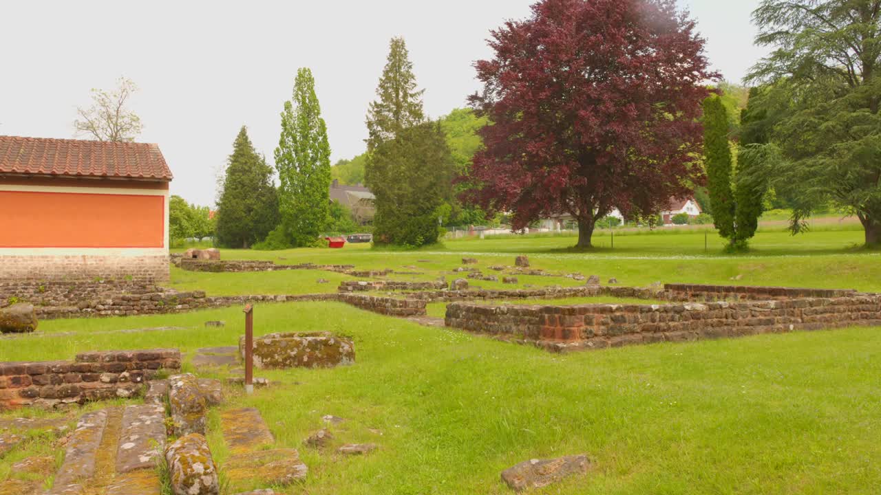 Ancient Ruins and Stone Walls in a Grassy Field