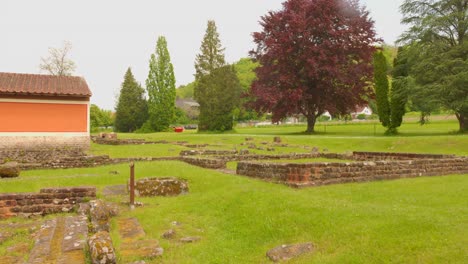 ancient ruins and stone walls in a grassy field