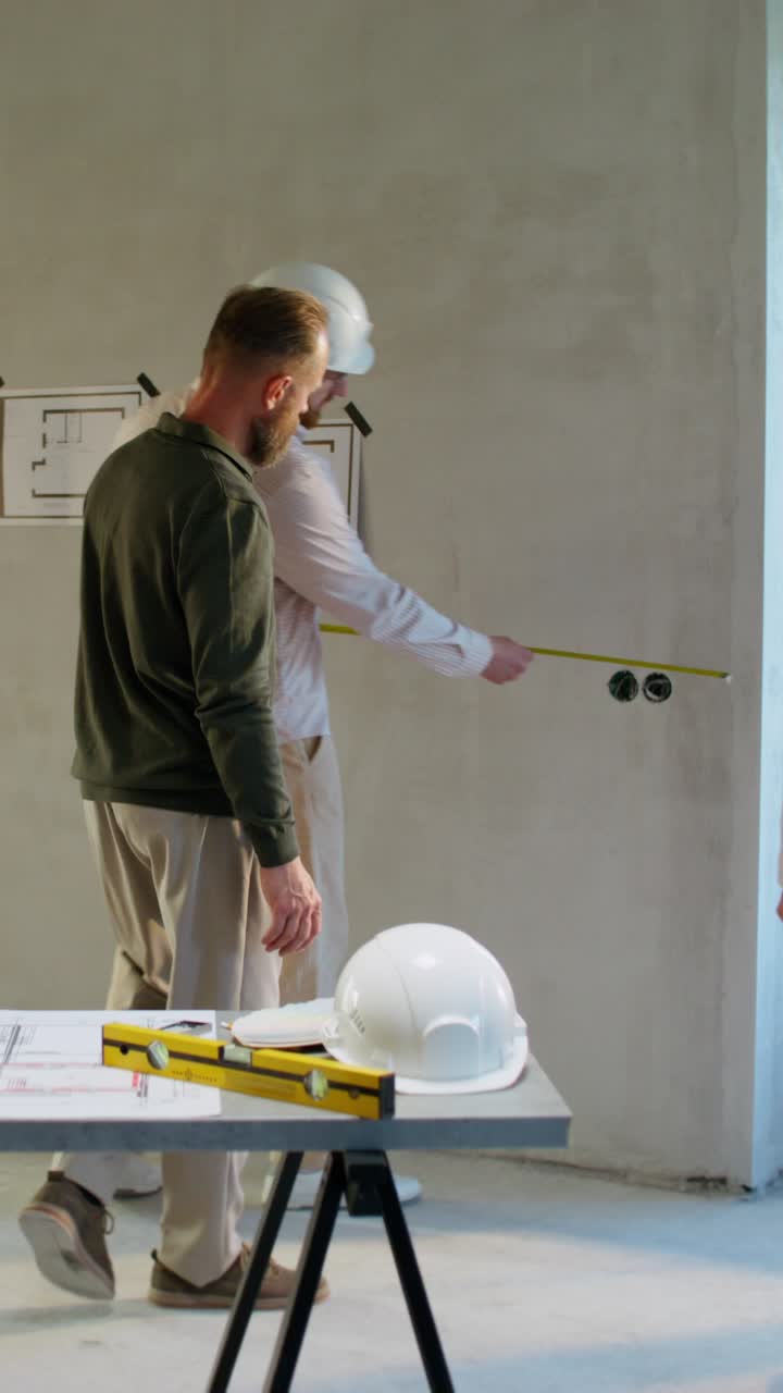 Construction Team Inspecting Building Plans