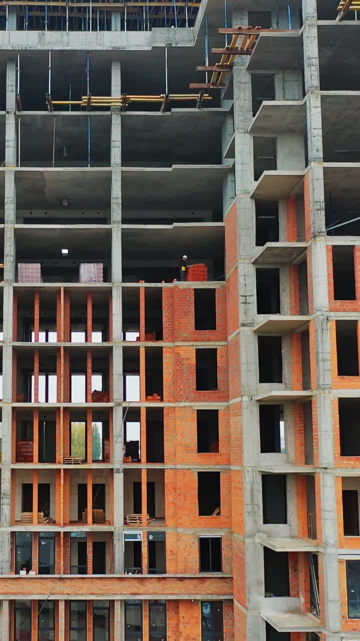 Construction of a residential apartment complex. Aerial view. Vertical video