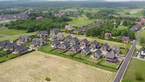 Toma-Aérea-De-Una-Zona-Residencial-Con-Casas-Unifamiliares-Modernas-En-Verano