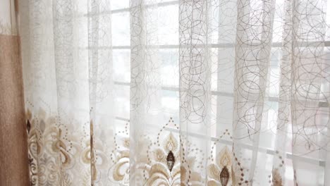 beige and white sheer curtains at a window