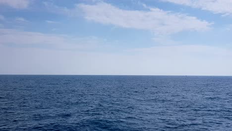 view of the ocean and clouds in the sky. blue sky with clouds in sunny weather over the ocean.