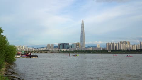 a leisurely day windsurfing on the han river in seoul, south korea with the lotte world tower on the city skyline