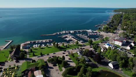 drone shot flying over sister bay, wisconsin and showing lake michigan