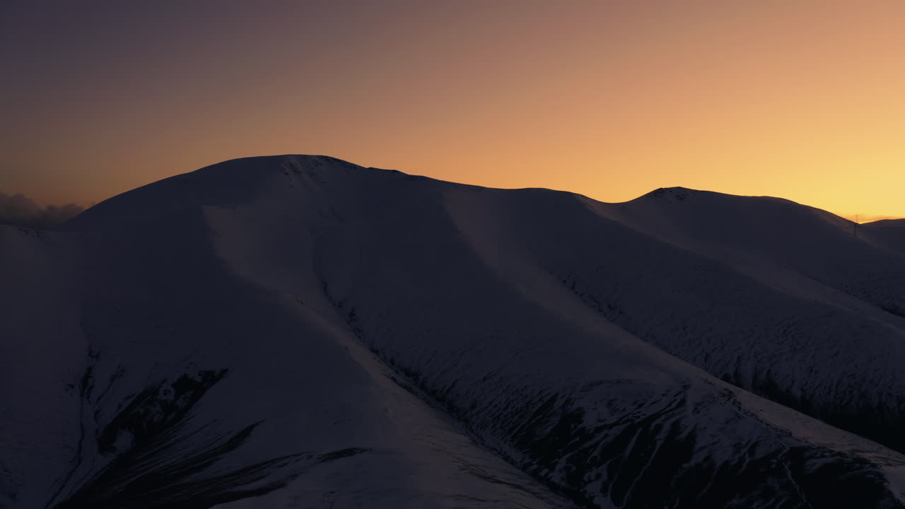 Beautiful sunset behind the snowy mountain