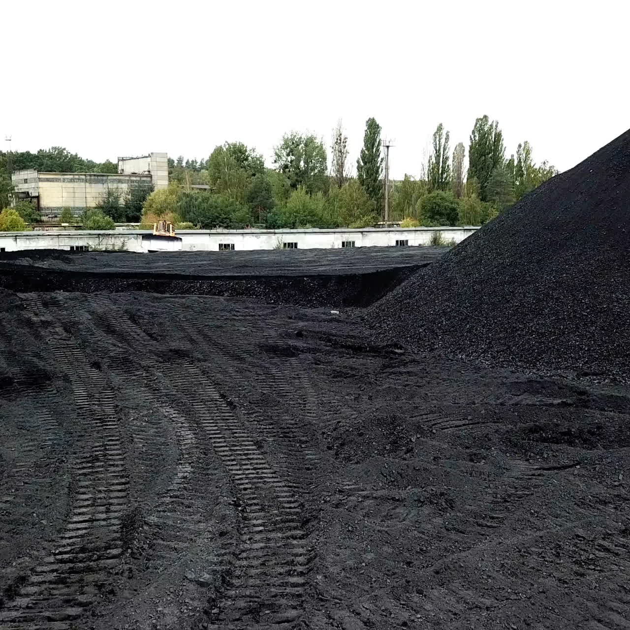Multi-ton bulldozer works. Extractive industry, anthracite. Aerial view.
