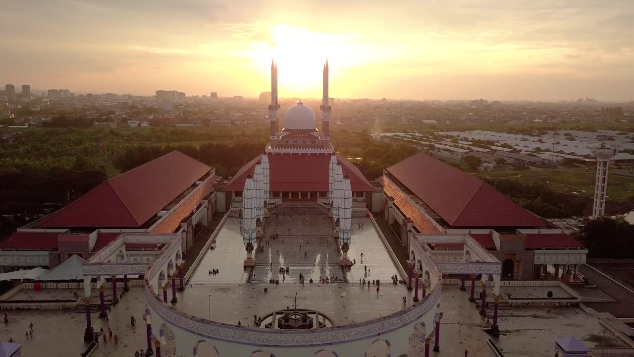Aerial view of the great Mosque of Central Java (MAJT) in suset time. Th sun is orange and the weather is cloudy.