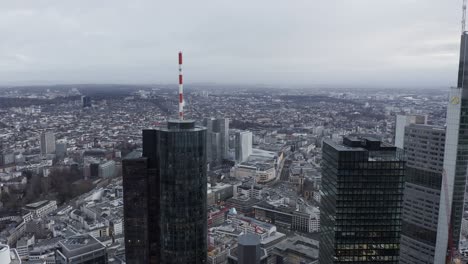 upper storeys of tall high rise business buildings towering high above town. cityscape in background. frankfurt am main, germany