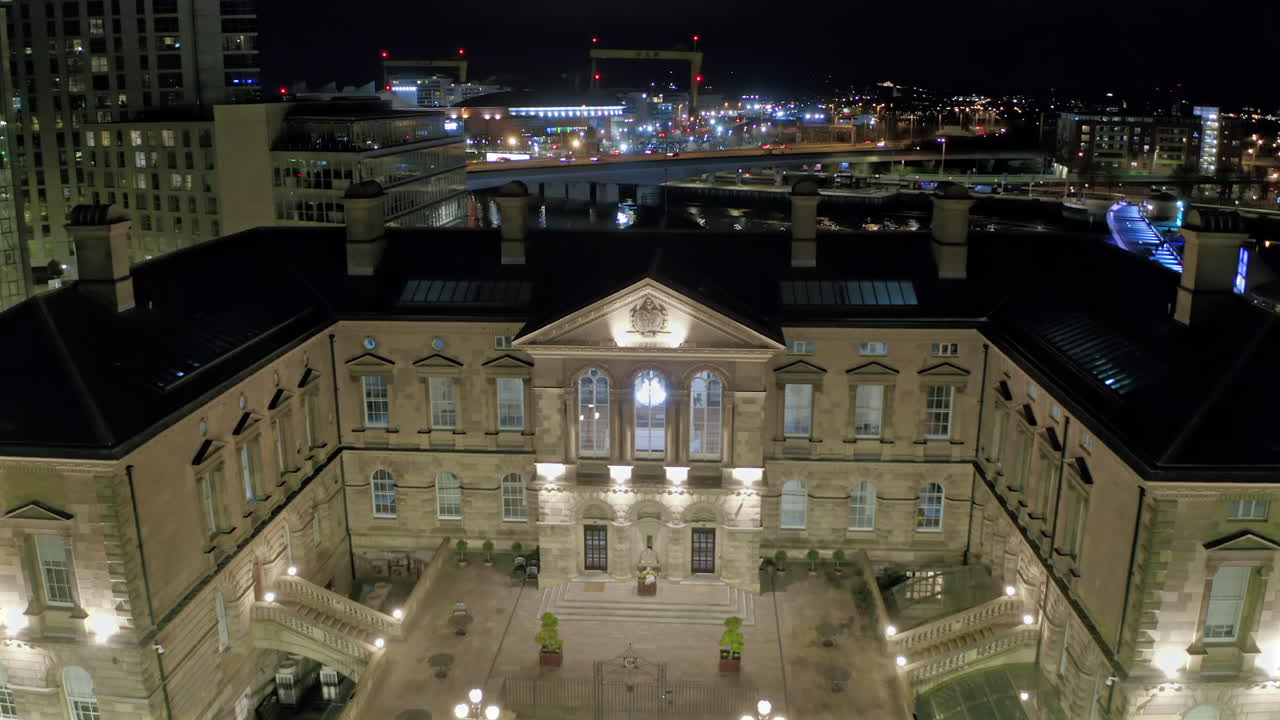 Aerial view of historic Custom House building with dramatic nighttime lighting in central Belfast