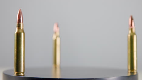 Three bullets rotating on display