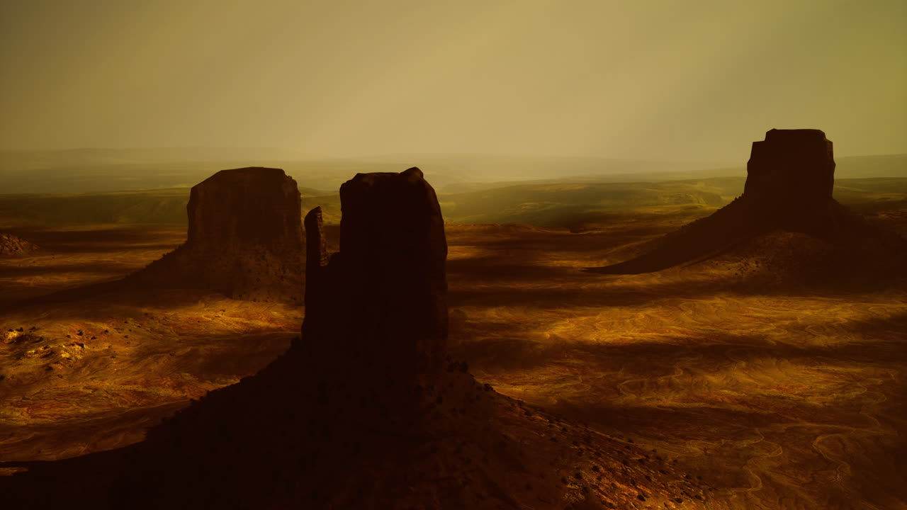 Majestic rock formations against a golden desert landscape at dusk
