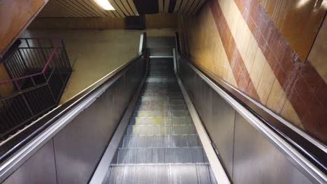 Automatic-electric-metallic-vintage-retro-staircase-goes-down-first-person-POV-shot-underground