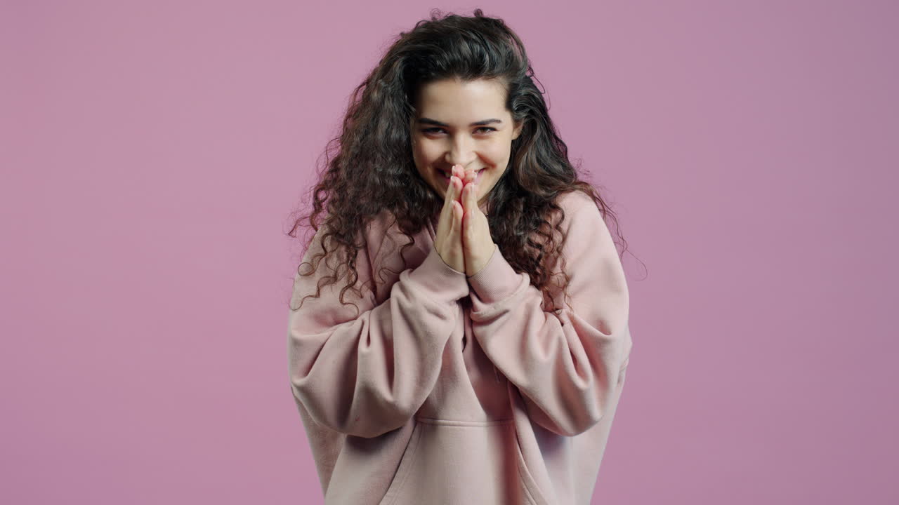 Woman in Pink Hoodie with Hands Together