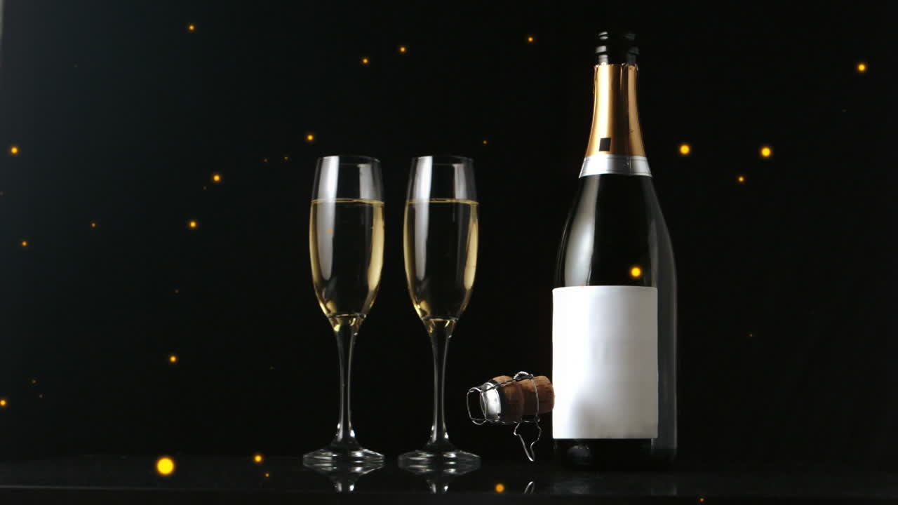 Animazione di punti dorati su champagne e bicchiere su sfondo nero