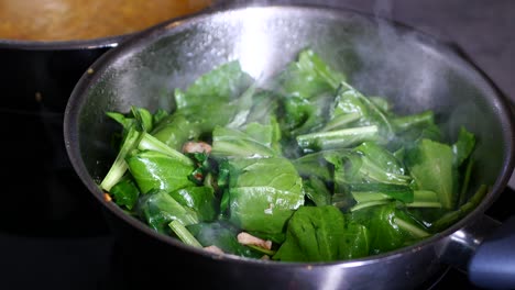 cooking spinach in a pan