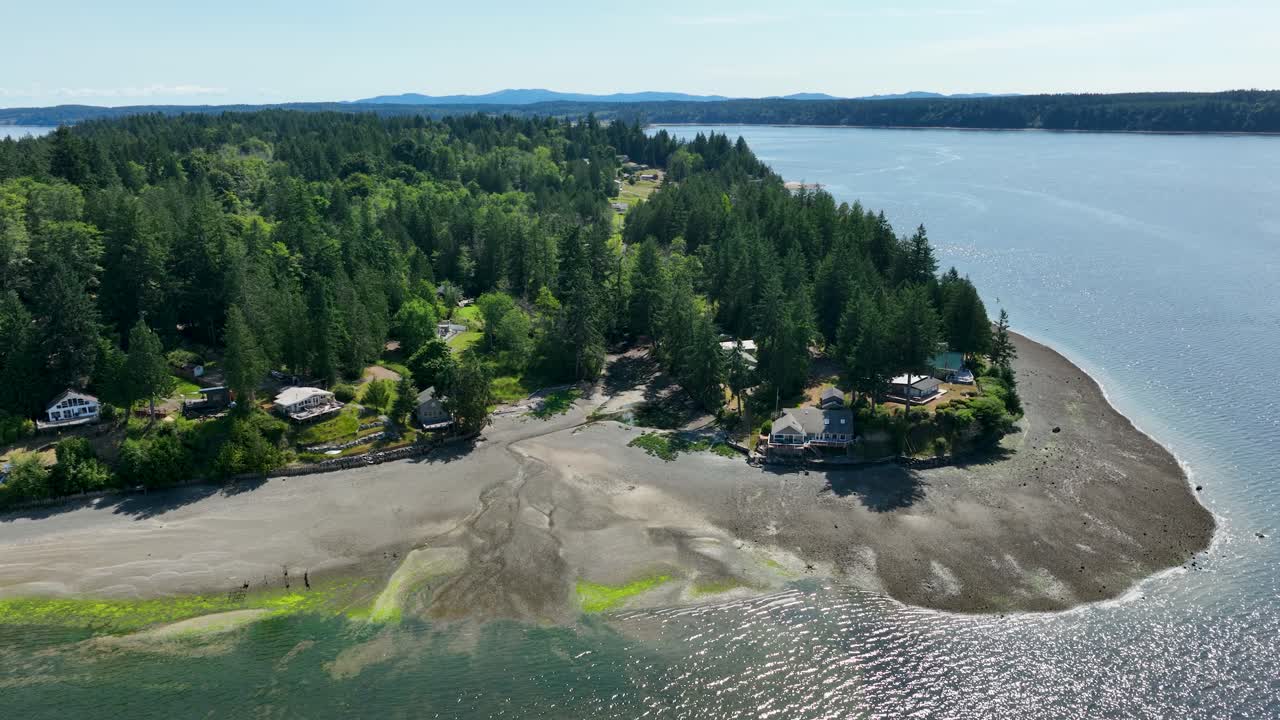 Aerial view of Herron Island's shoreline during low tide with exposed beaches
