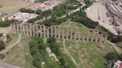 aerial orbit around old roman stone aqueduct ruins, archaeology in merida, spain