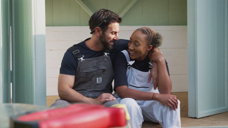 Portrait-Of-Couple-Taking-A-Break-From-Building-Outdoor-Summerhouse-In-Garden