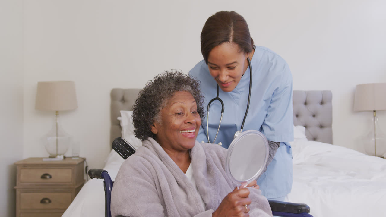 Mixed race woman being visited at home by a nurse. Social distancing and self isolation in quarantin