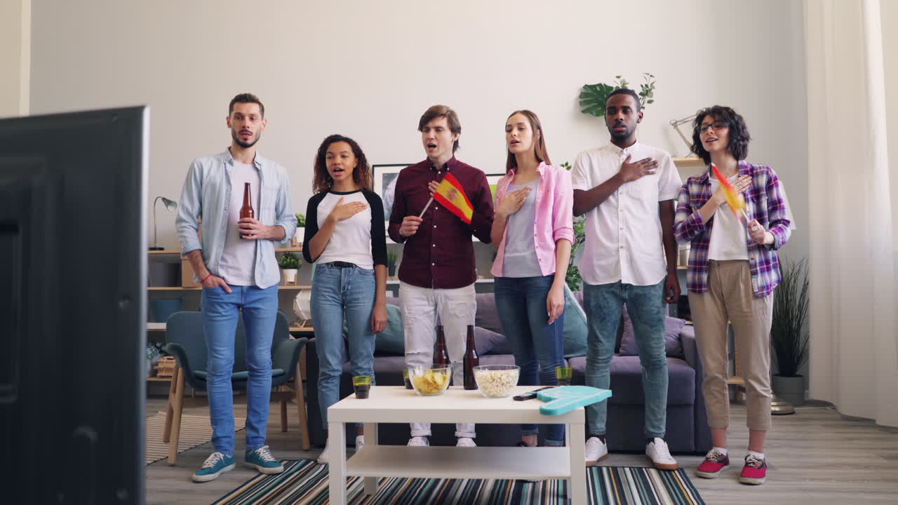 Friends Watching a Sporting Event and Singing the National Anthem