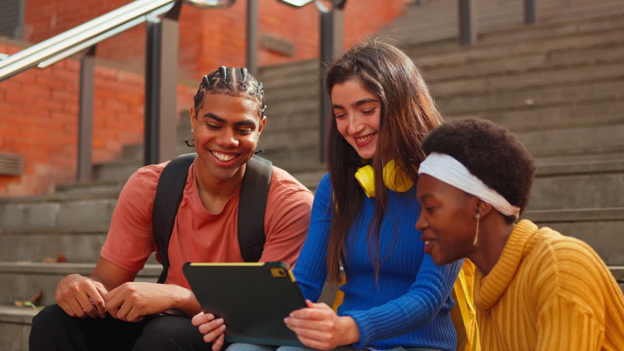 Group of students using tablet outdoors