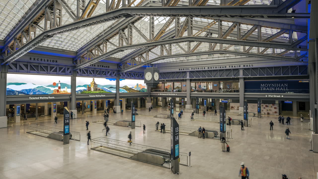 New York NY USA-January 8th, 2021 Visitors to the Daniel Patrick Moynihan Train Hall at Pennsylvania Station in New York enjoy the new space from the top level