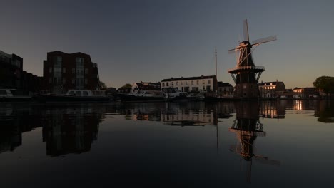 Windmill-De-Adriaan-along-the-Spaarne-river-in-Haarlem-city-centre-at-dawn-in-summer