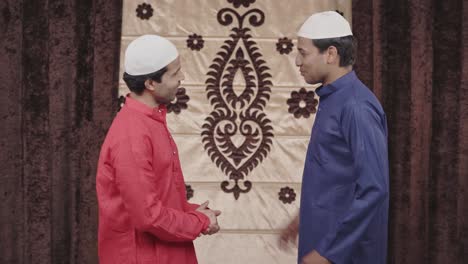 two excited muslim men talking to each other